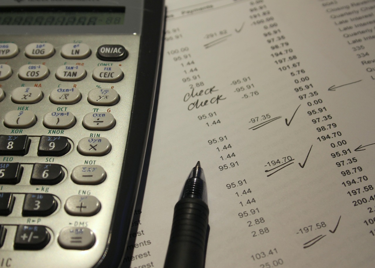 A printed credit report with a score range chart on a desk.