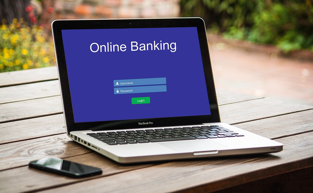 A person checking a bank account on a laptop.