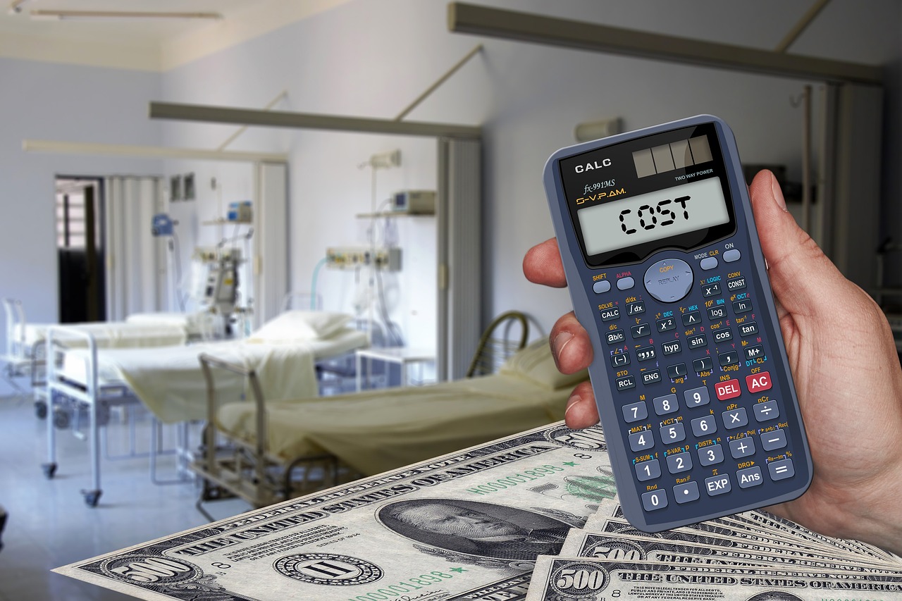 Medical bills and a calculator spread on a table.