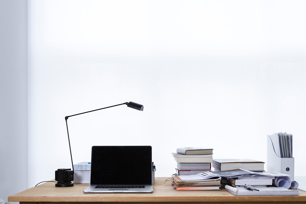 A laptop and paperwork on a desk during an online dispute.