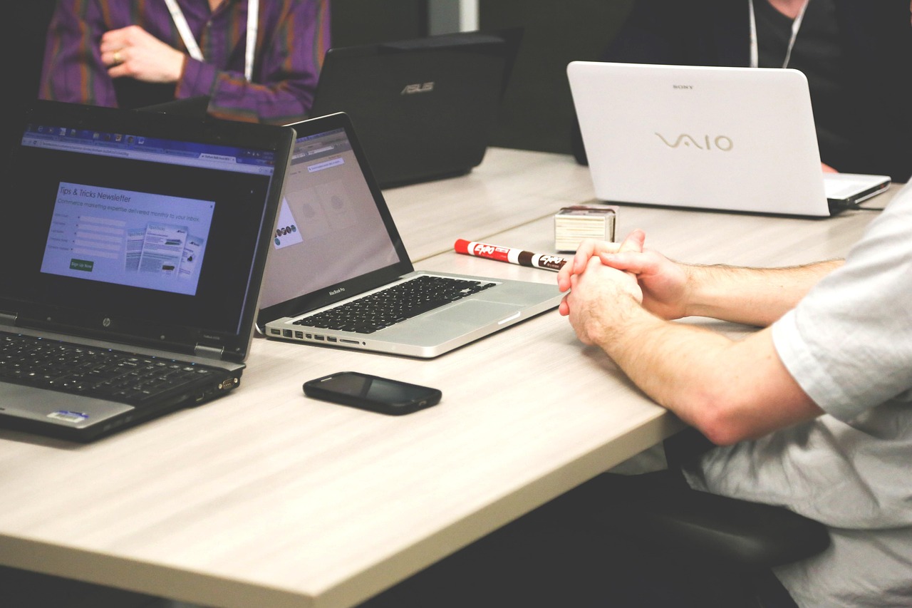 An employee at a desk reviewing retirement plan options on a laptop.