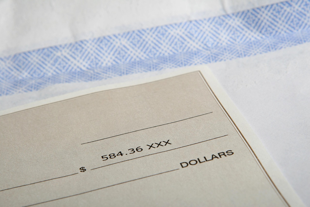 A paper check being prepared for deposit.
