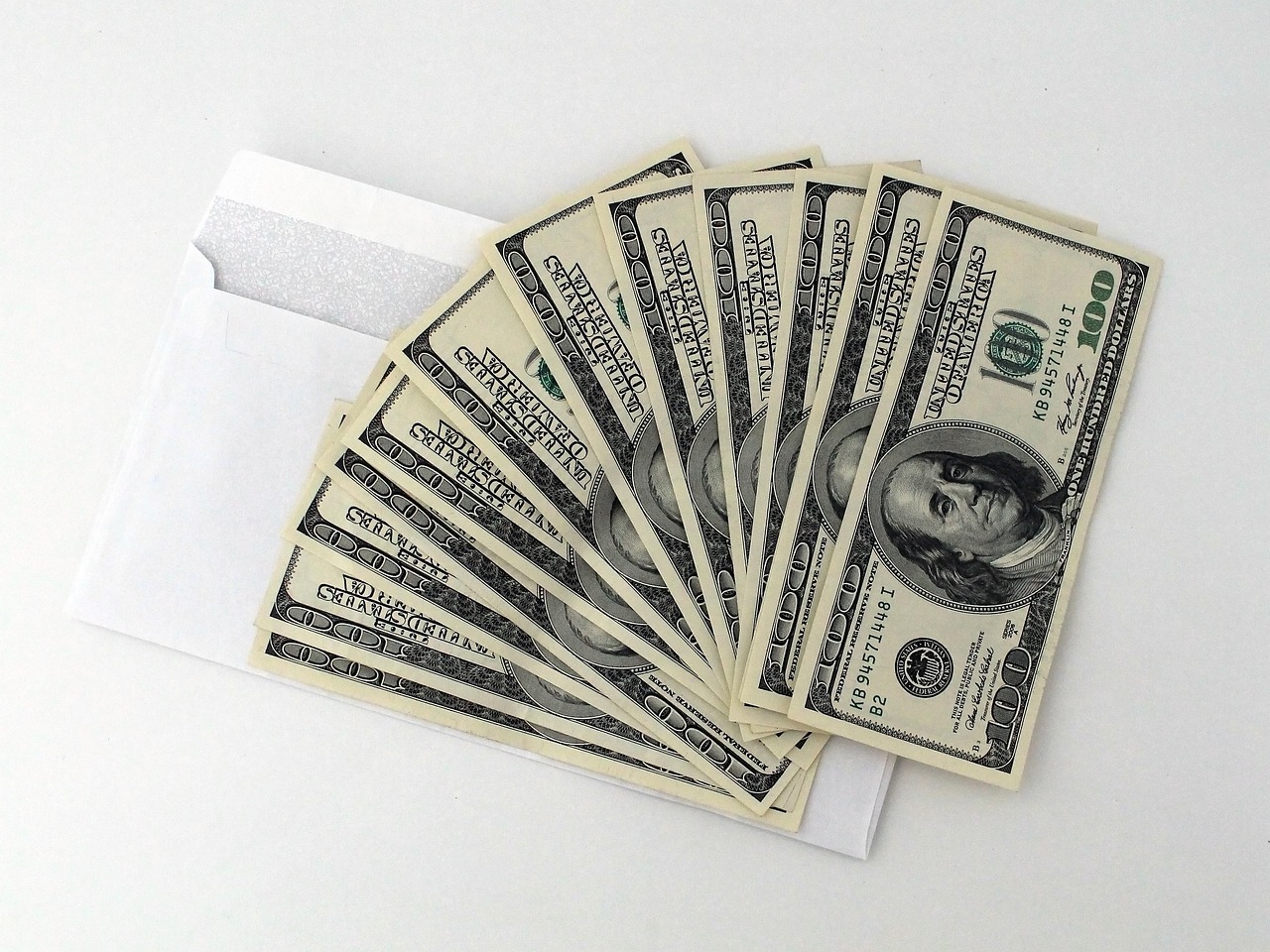 Labeled paper envelopes holding cash for different spending categories.